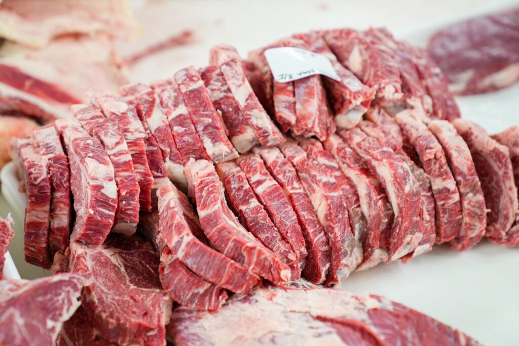 A close-up shot of sliced beef in a meat processing setting, showcasing freshness and detail.